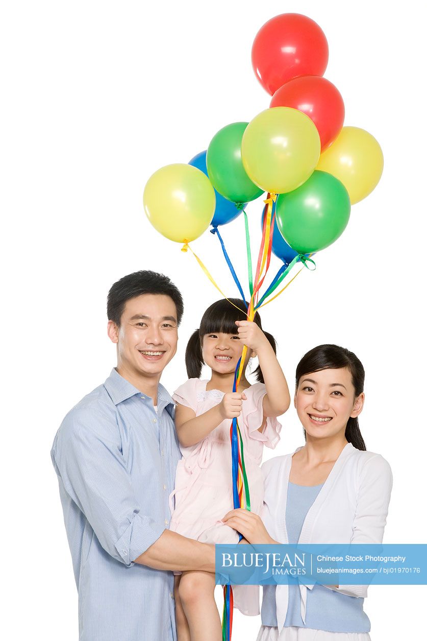 Portrait of Chinese family with balloons