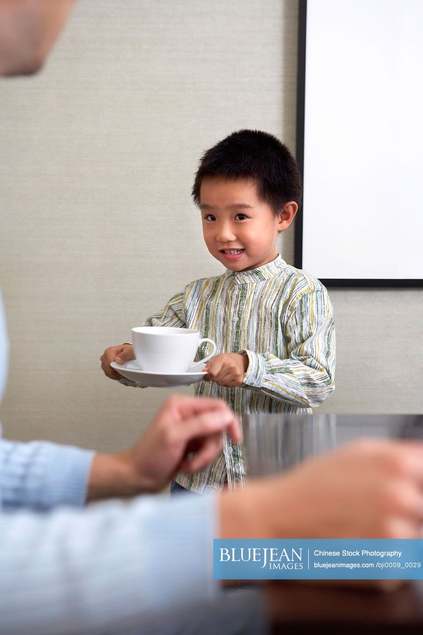 Chinese Boy Carrying Cup Of Tea