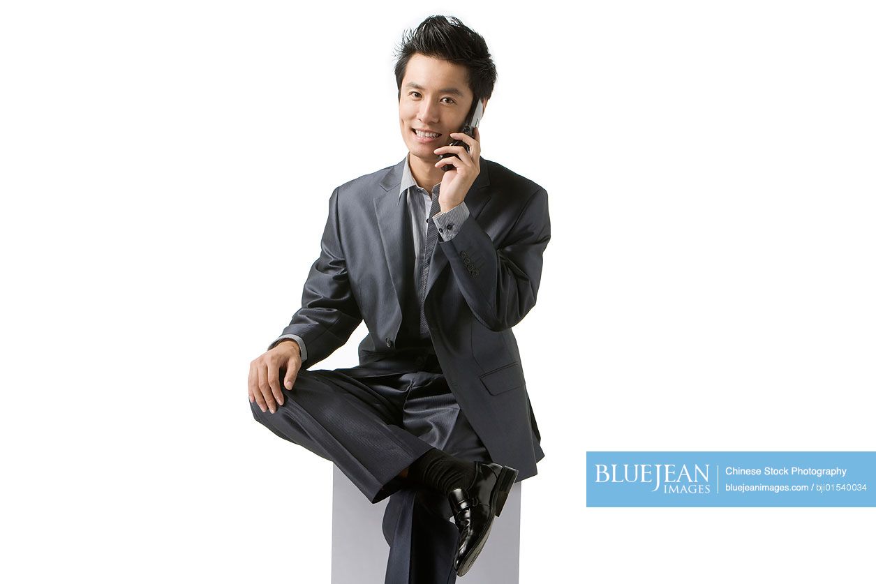 Chinese businessman using cell phone