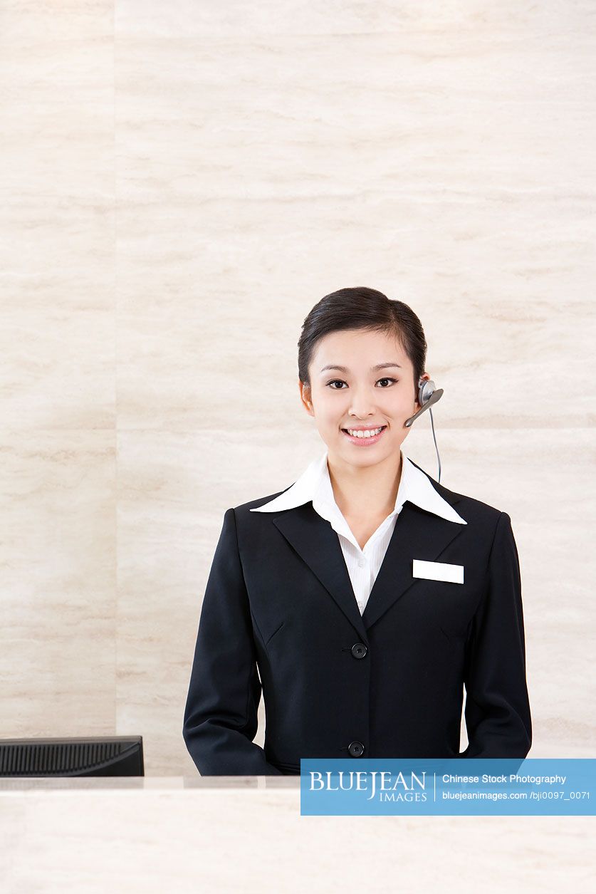 Chinese Young Receptionist At Front Desk