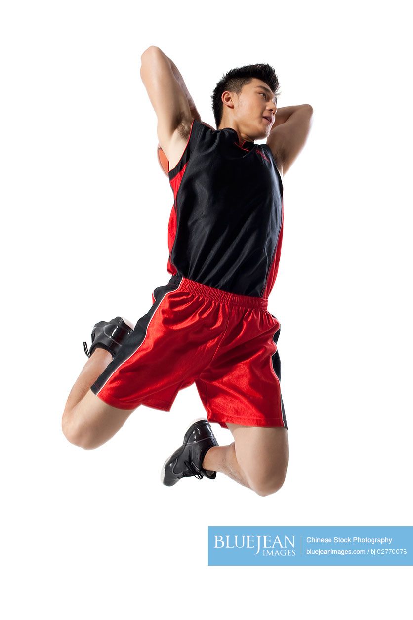 Chinese man jumping to shoot basketball