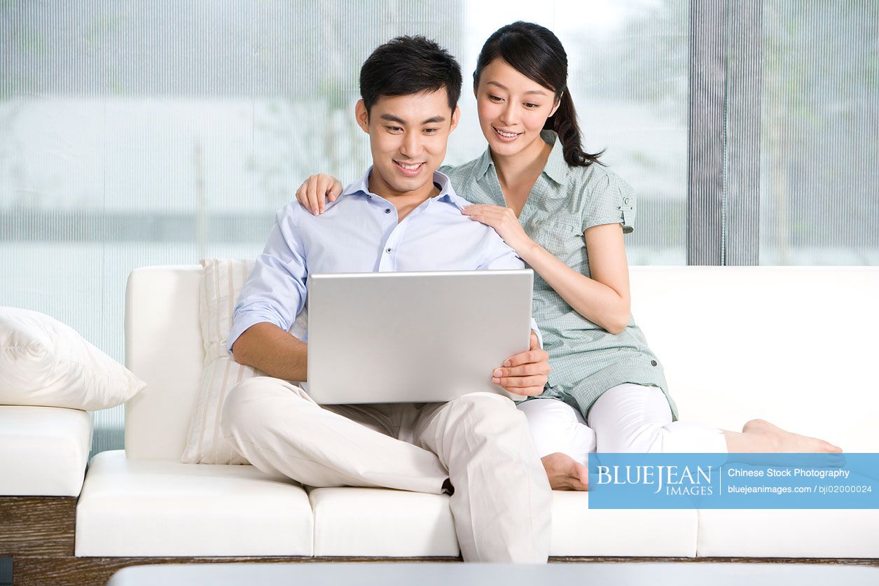 Portrait of  Chinese couple using  laptop t home