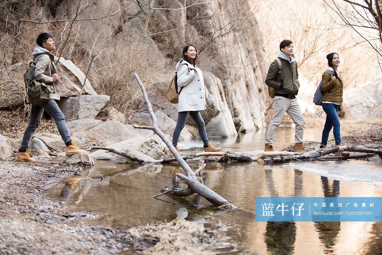 Happy young Chinese friends enjoying winter outing