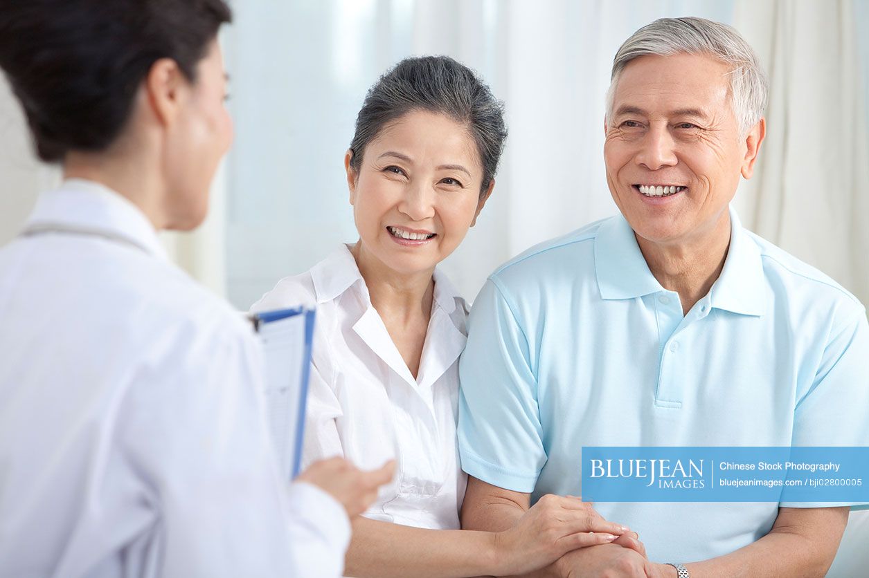 Chinese family doctor examing senior patient