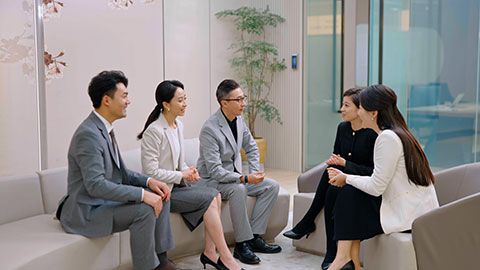 Confident Chinese business people talking in meeting room