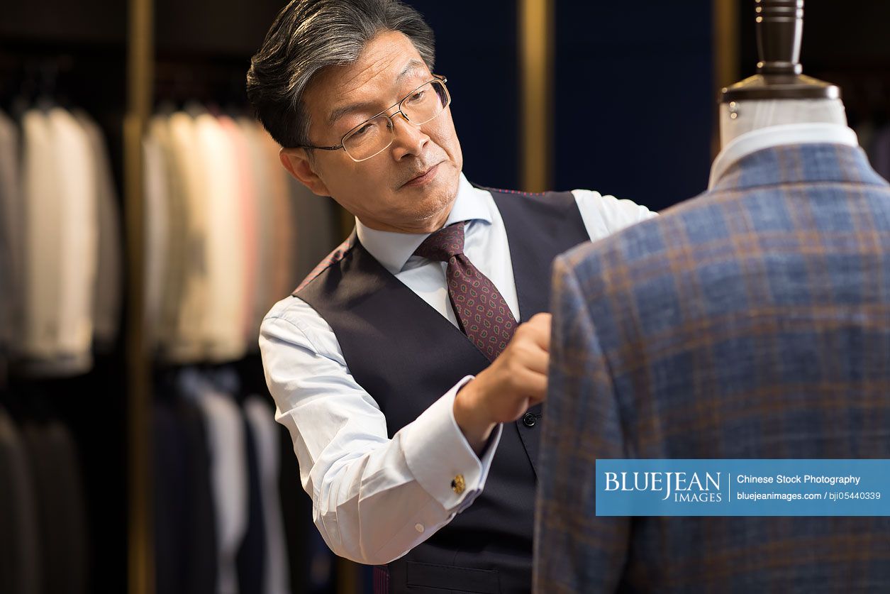 Confident Chinese fashion designer working