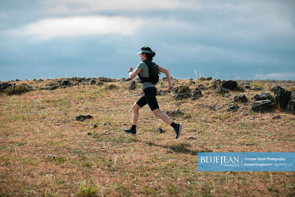 Chinese female trail runner training in nature