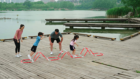 A young family works out in the park, staying active and healthy