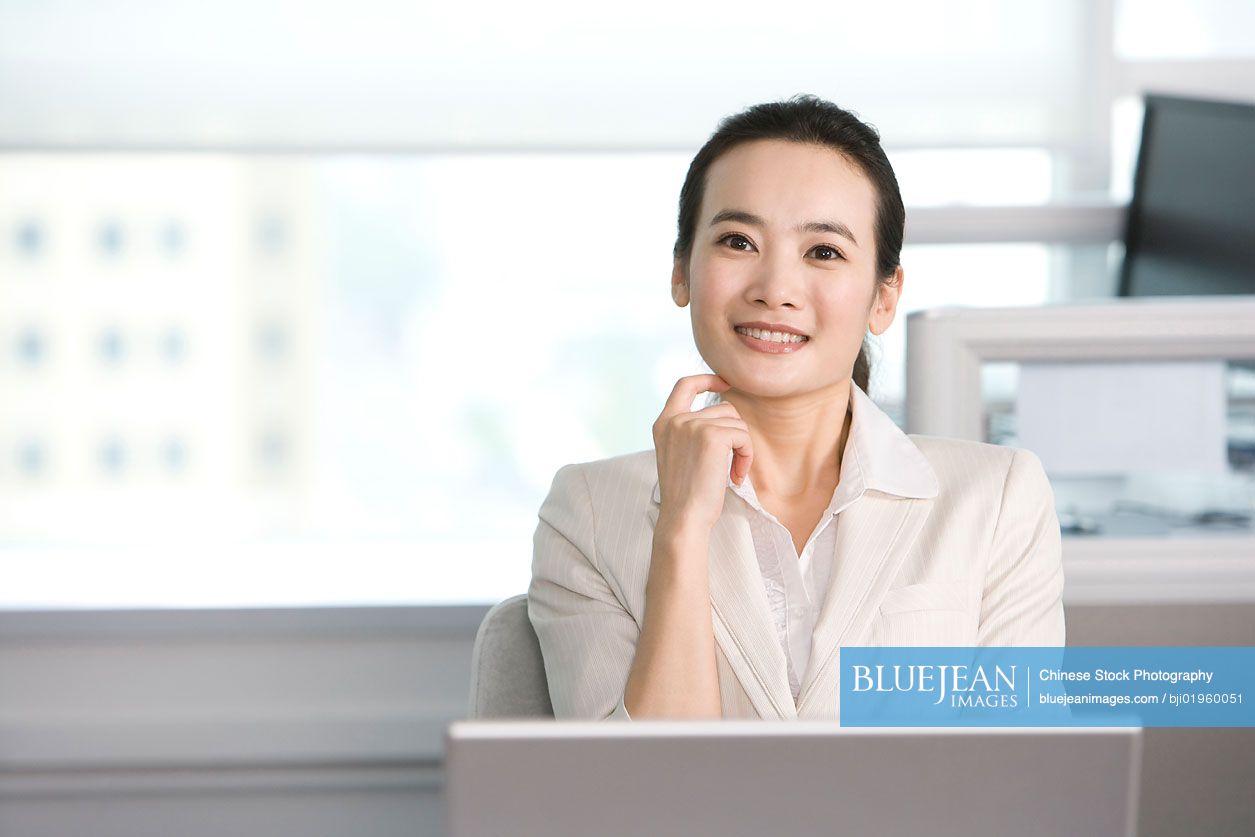 Chinese office worker at her desk