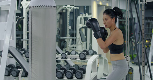 Young Chinese woman boxing at gym,4K