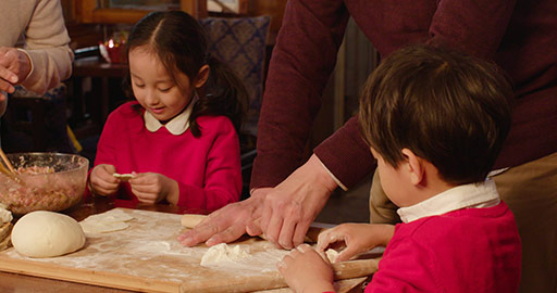 Happy Chinese family making dumplings at home,4K