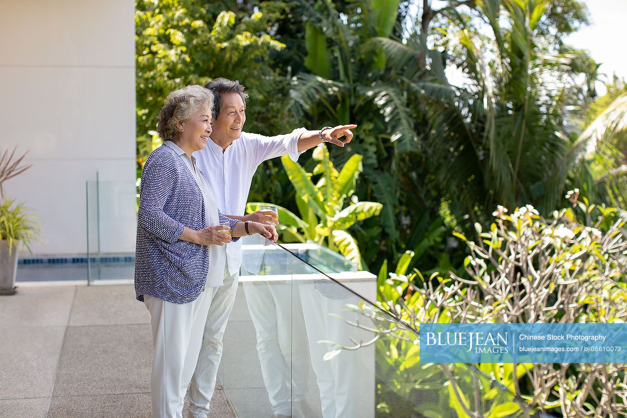 Happy senior Chinese couple relaxing on balcony-High-res stock photo ...