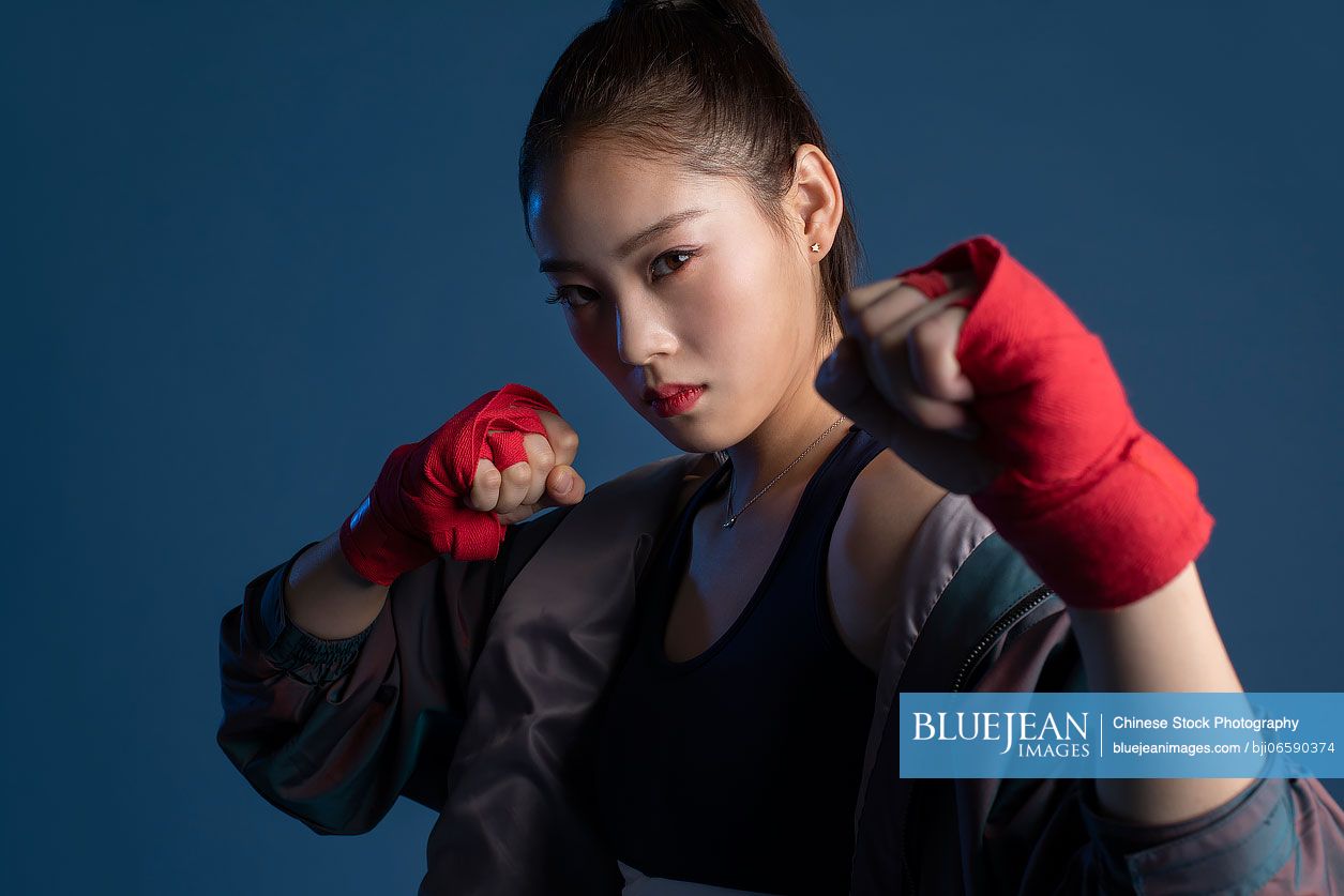 Confident young Chinese woman in hand wraps