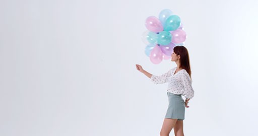 Cheerful young Chinese woman holding balloons,4K