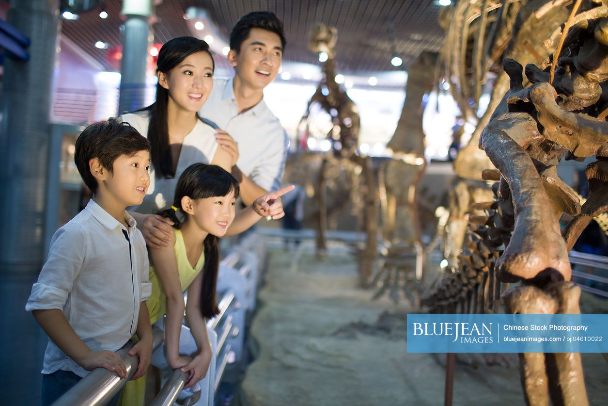 Young Chinese family in museum of natural history