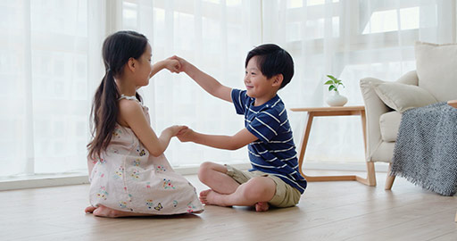 Happy Chinese sibling playing in living room,4K