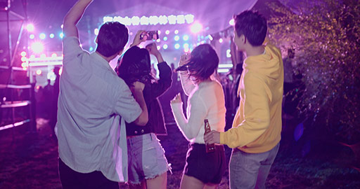 Happy young Chinese friends having fun at music festival,4K