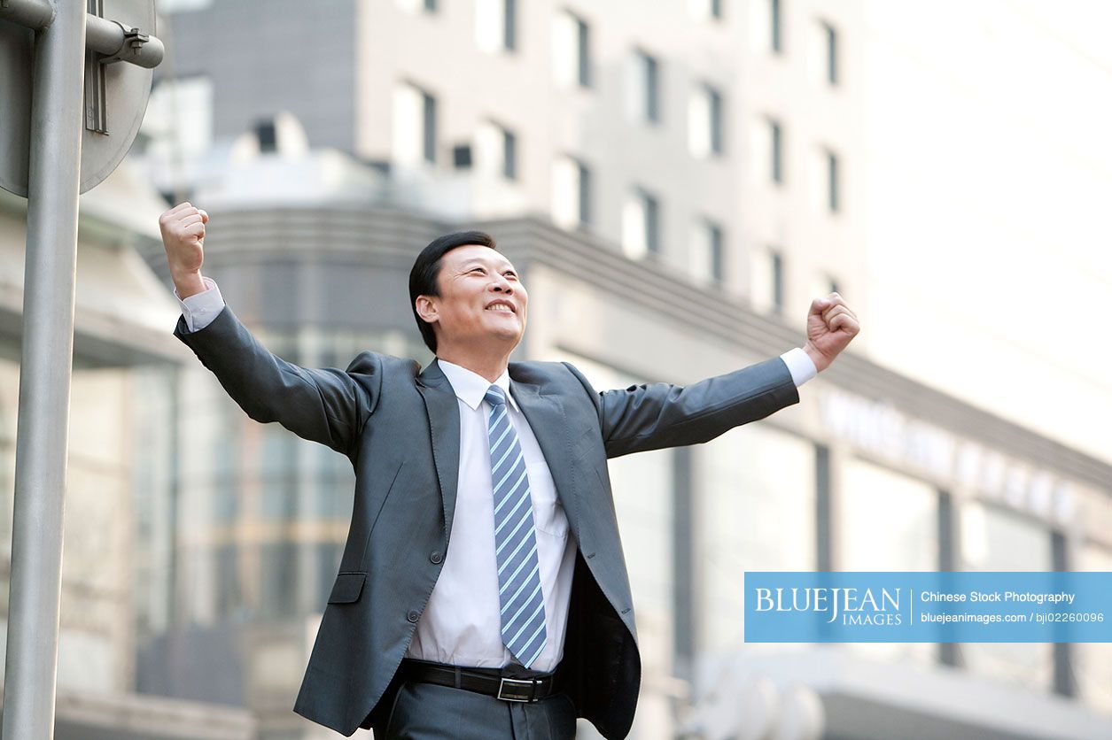 Chinese businessman celebrating on the street