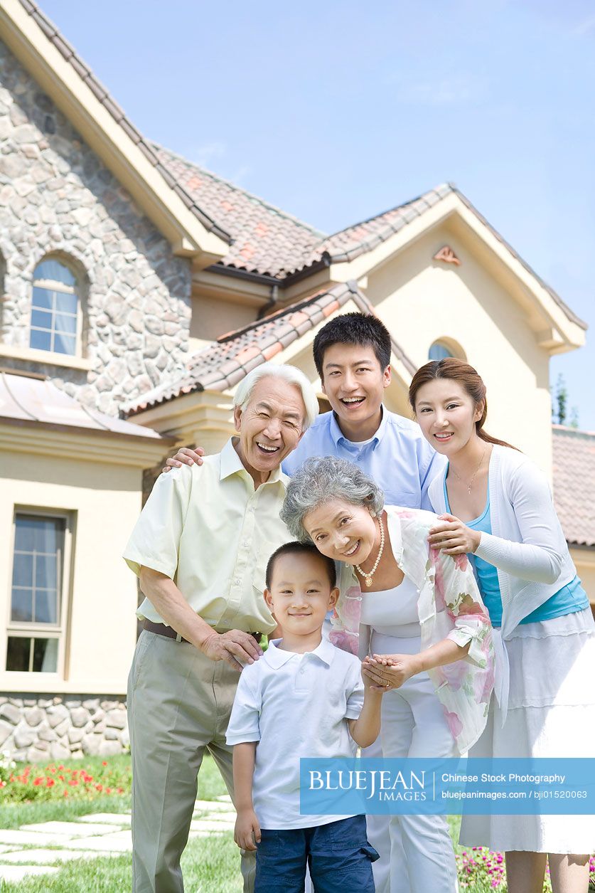 Chinese family in front of house