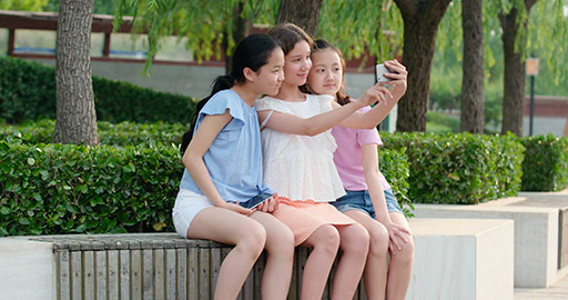 Teenagers taking selfie with smartphone outdoors,4K