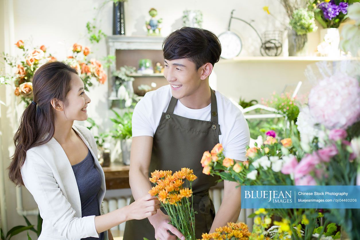 Chinese florist and customer in flower shop