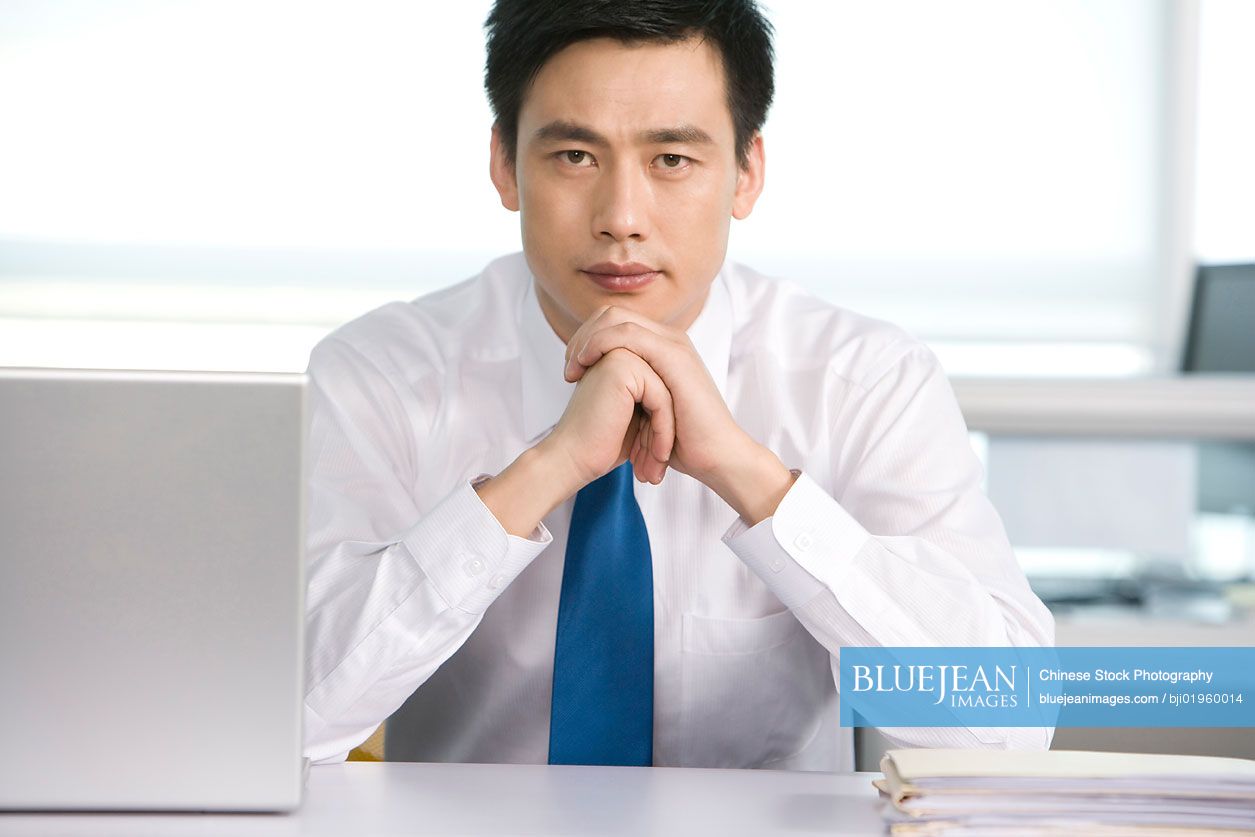 Chinese office worker at his desk