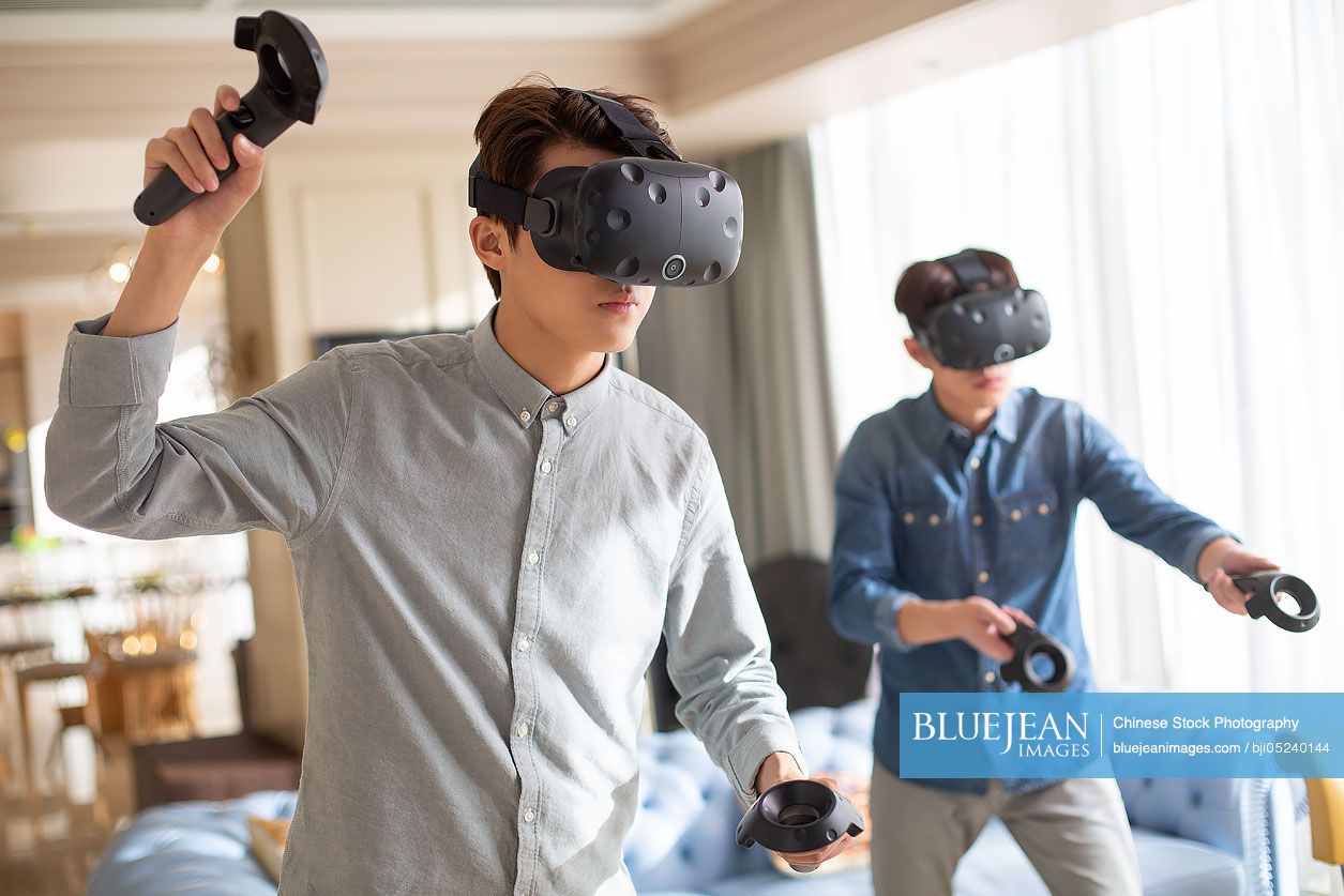 Young Chinese friends playing VR game