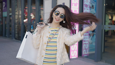 Cheerful young Chinese woman with shopping bags,4K