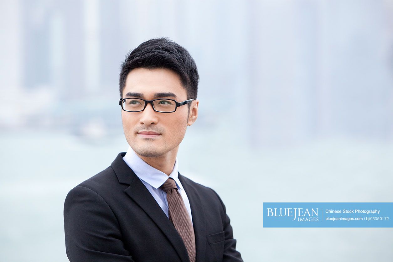 Refined Chinese businessman looking at view, Hong Kong