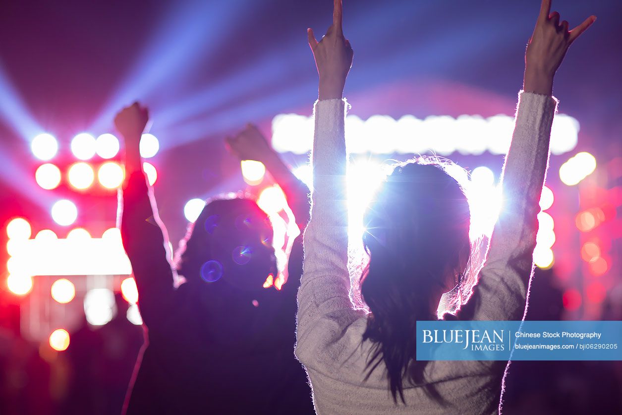 Happy young Chinese girls at music festival