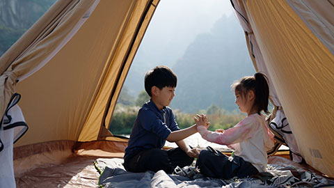 Cute Chinese Children relaxing in tent