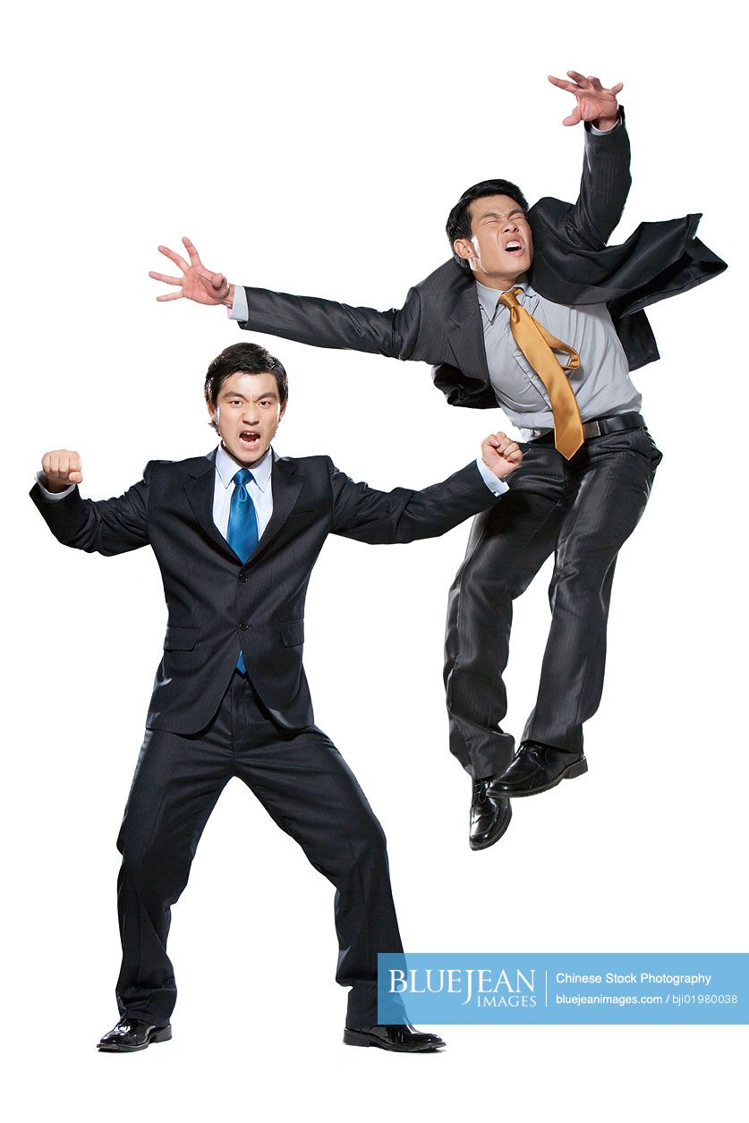 Two Chinese businessmen fighting on white background