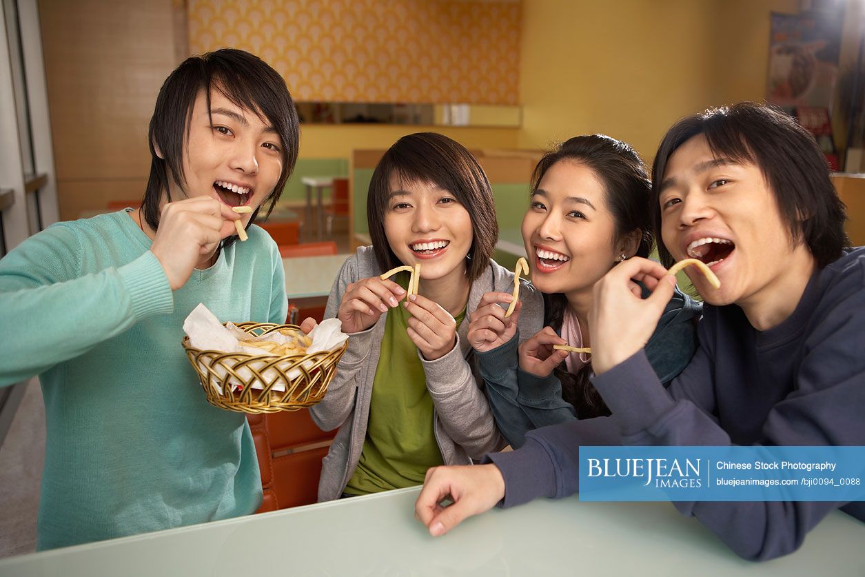 Chinese teenagers sharing French fries