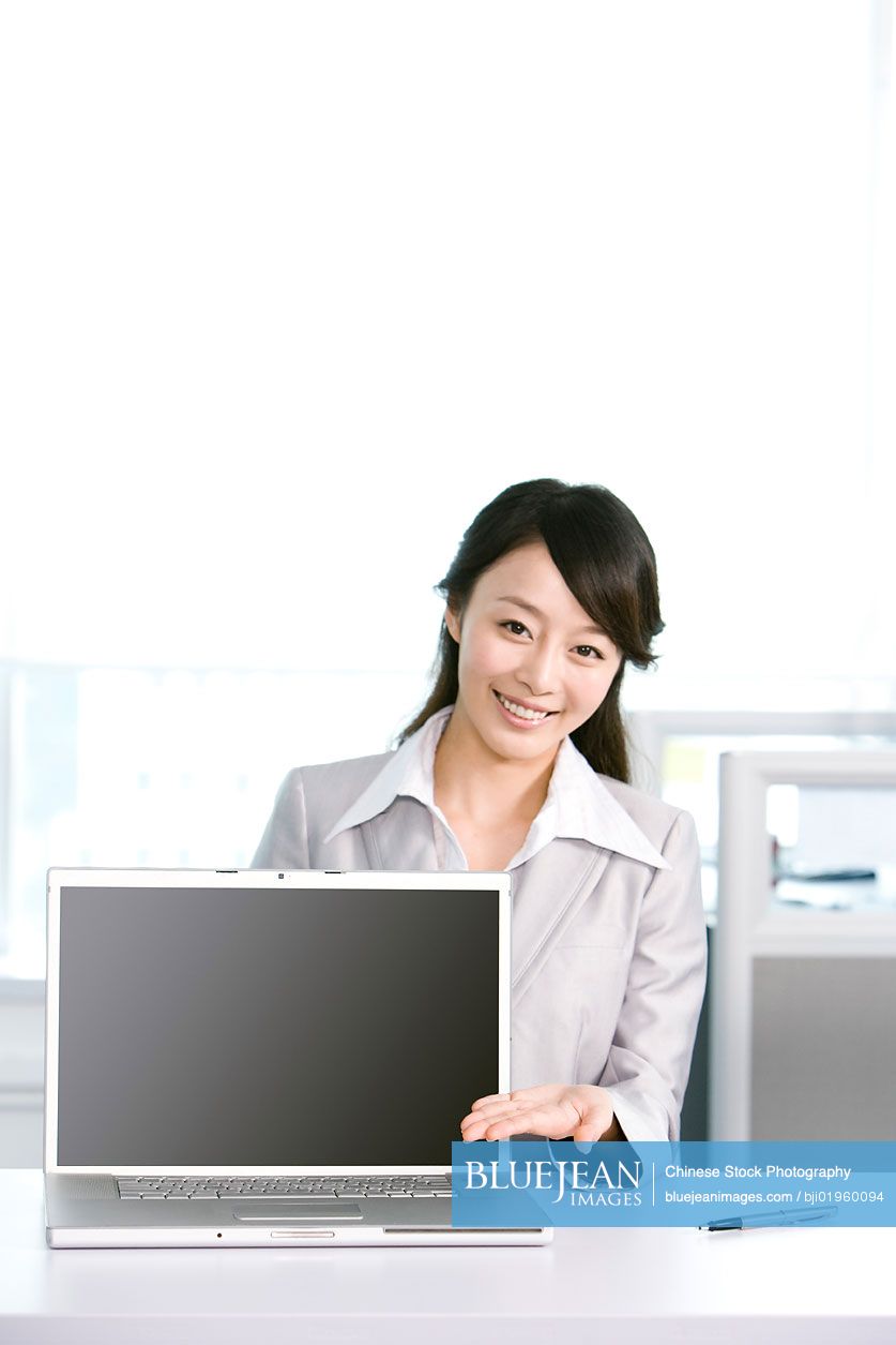 Chinese office worker at her desk