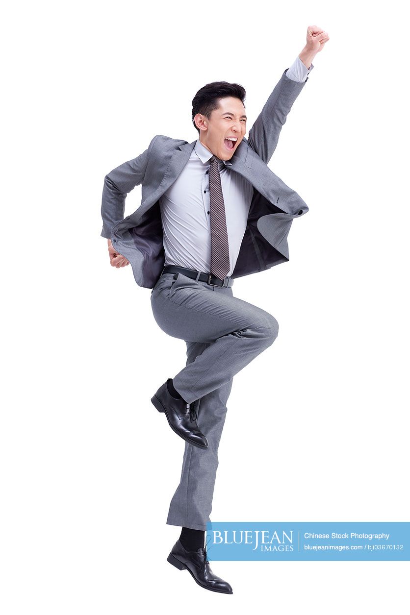 Excited young Chinese businessman cheering