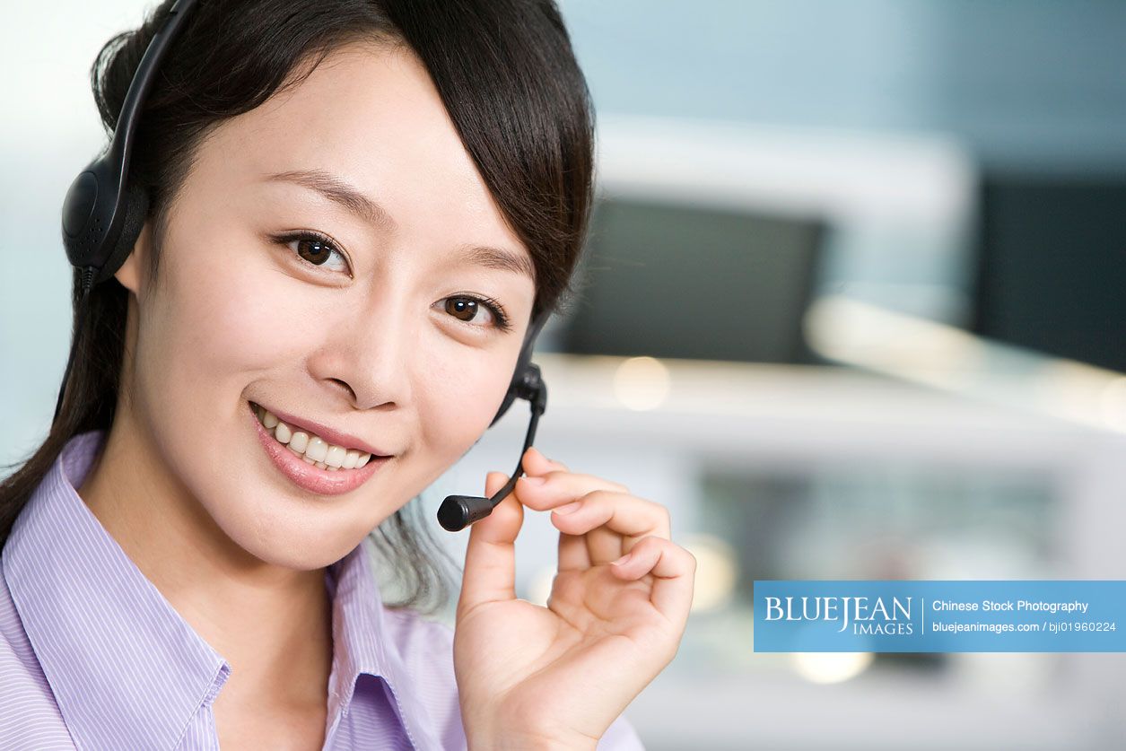 Chinese office worker with a headset