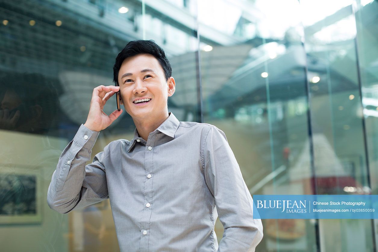 Mid adult Chinese man on the phone