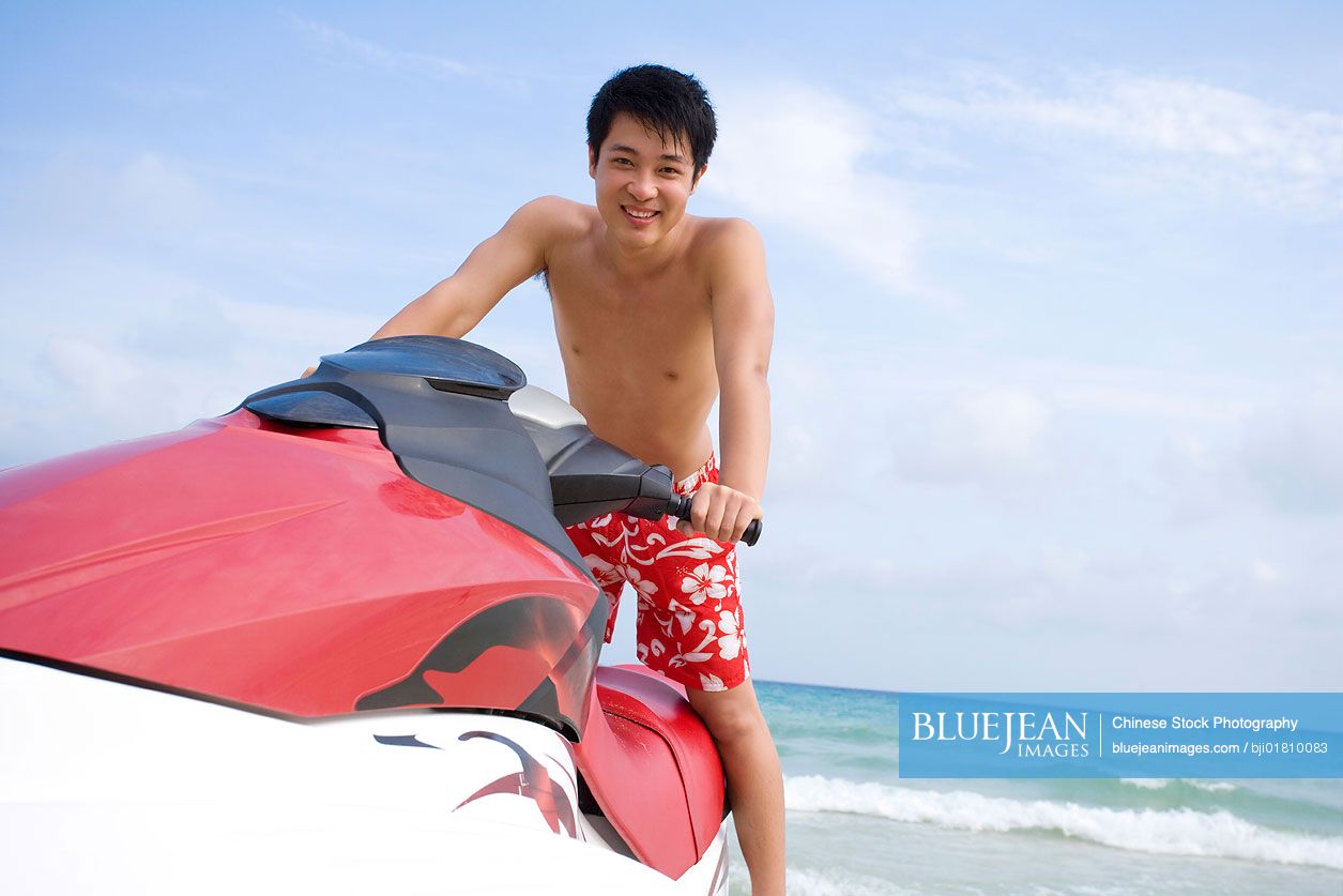 Young Chinese man on a jet ski