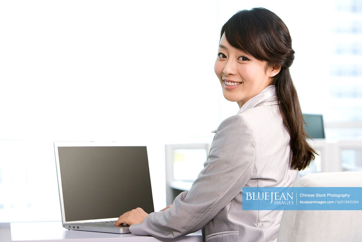 Chinese office worker at her desk