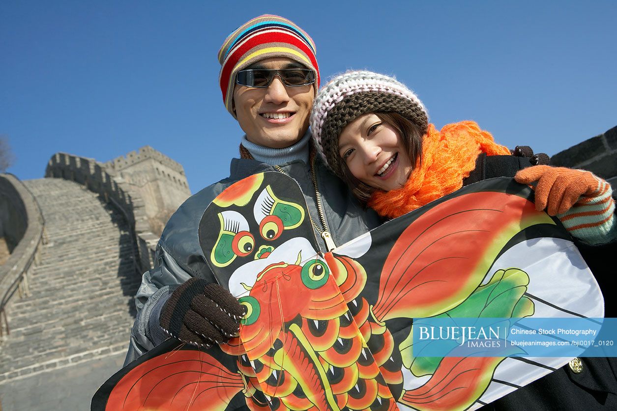 Young Chinese Couple On The Great Wall Of China With A Kite