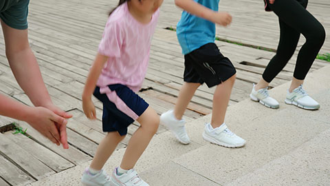 A young family works out in the park, staying active and healthy