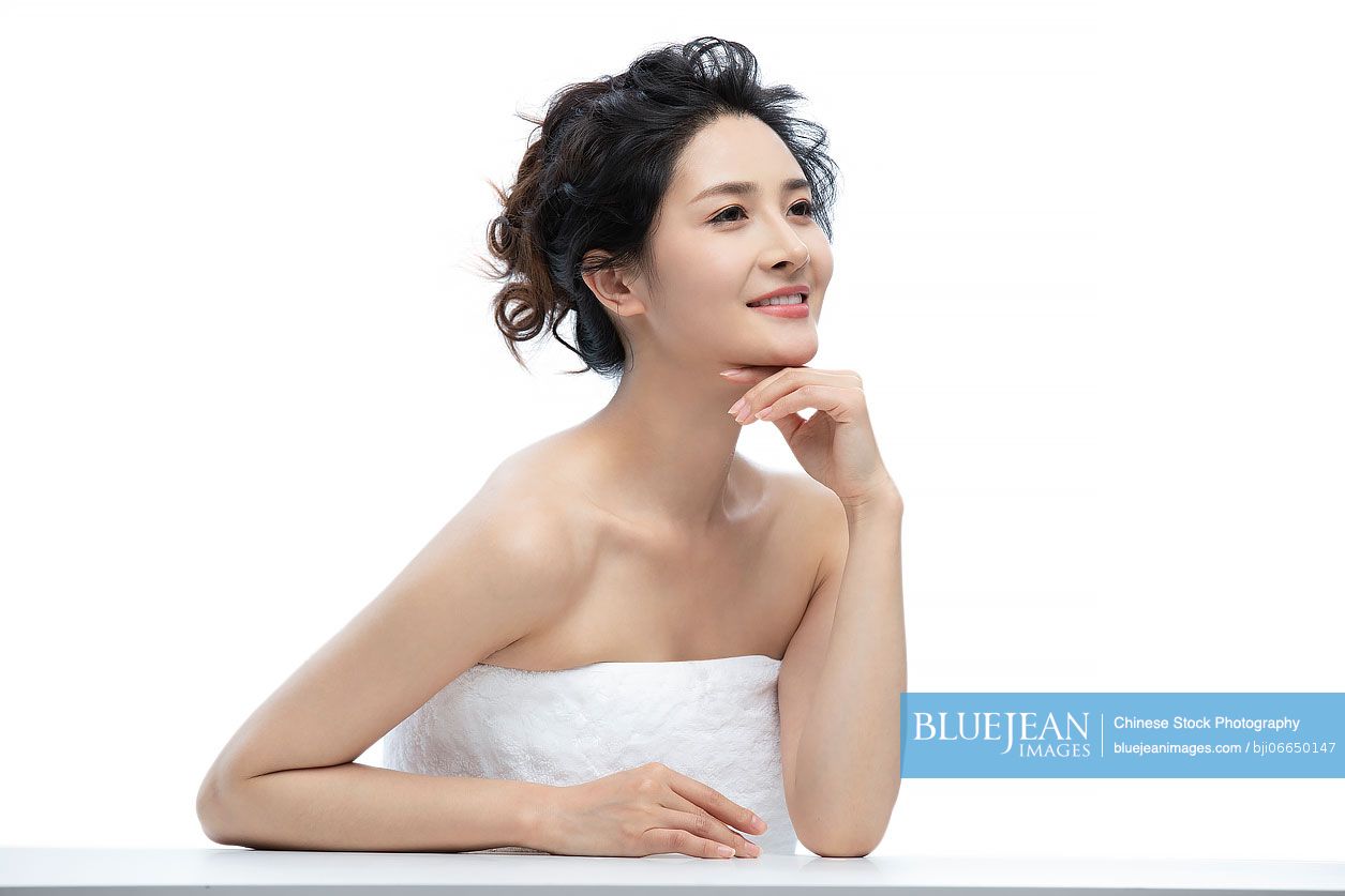 Beautiful young Chinese woman wrapped in towel
