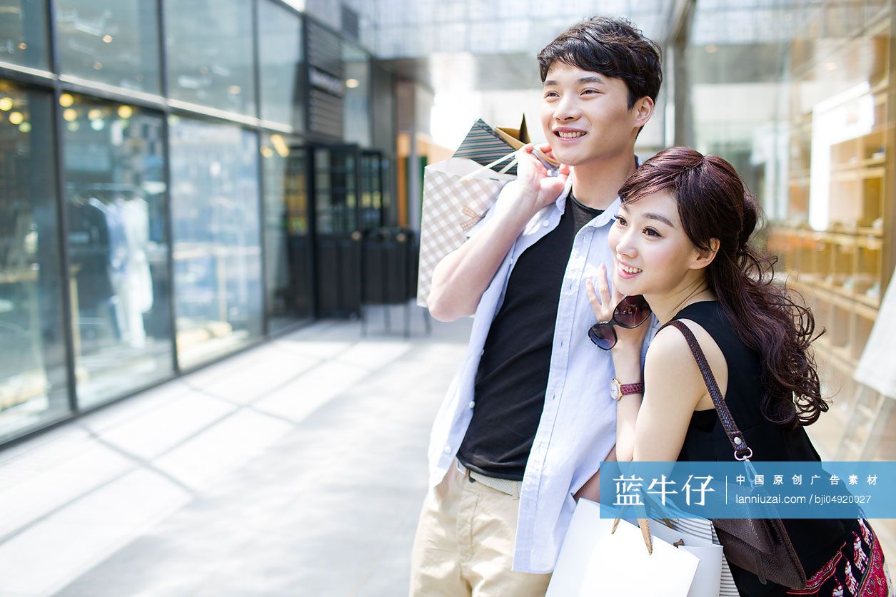 快乐的年轻情侣逛街购物