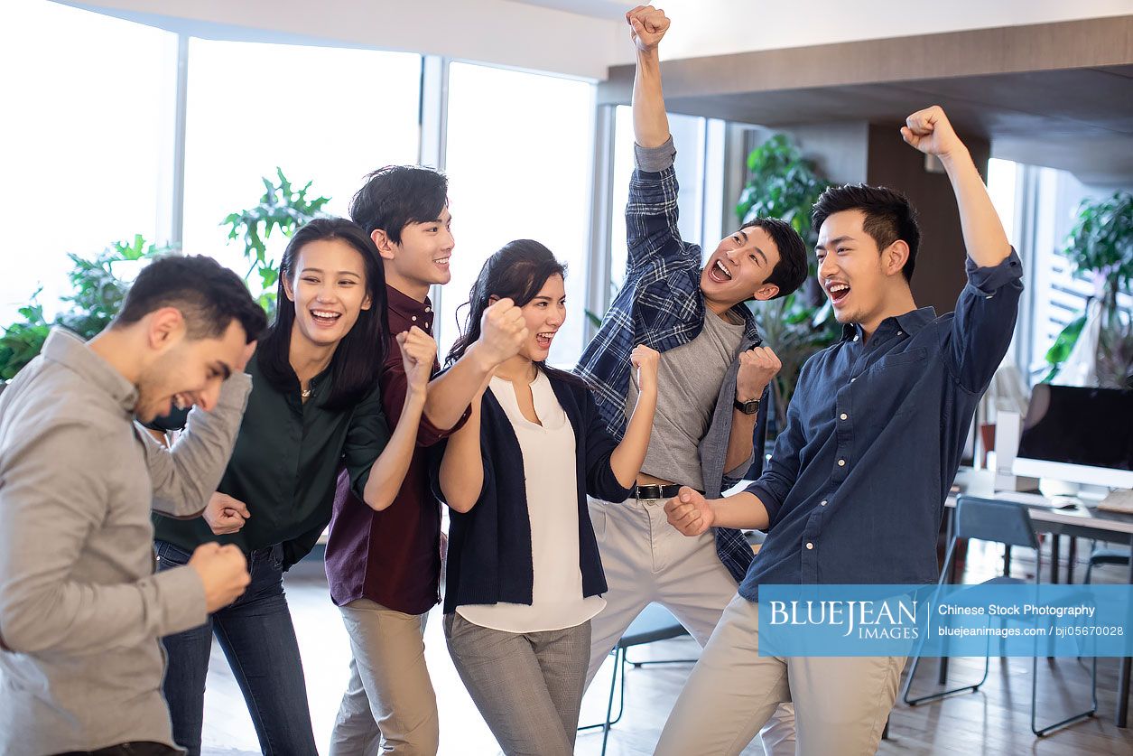 Young abroad students cheering in classroom