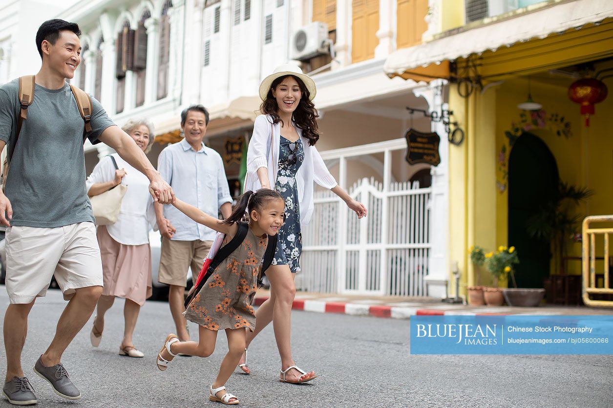 Happy family enjoying vacation on street