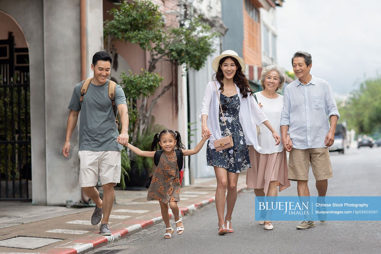 Happy family enjoying vacation on street