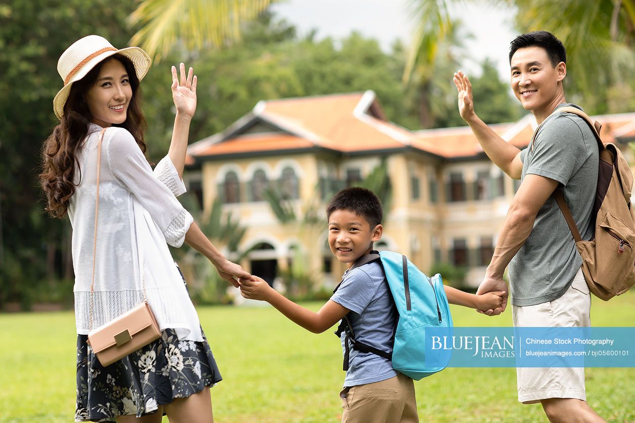 Happy young Chinese family enjoying vacation