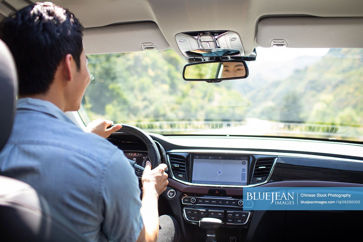 Young Chinese man enjoying road trip