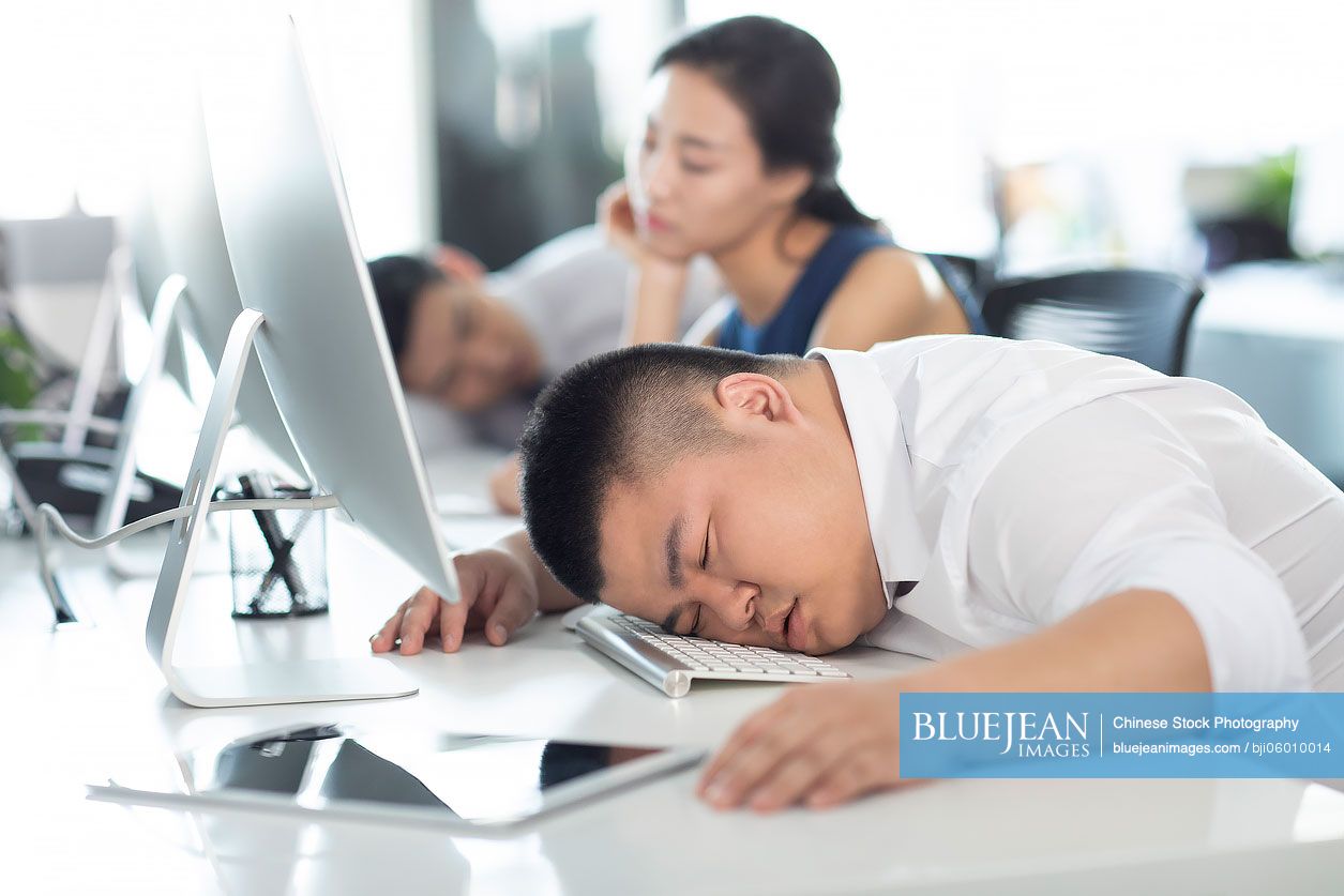 Chinese business people sleeping in office