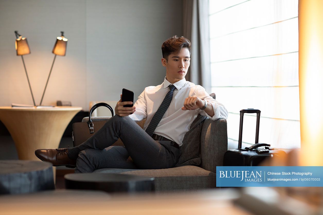 Young Chinese businessman in hotel room